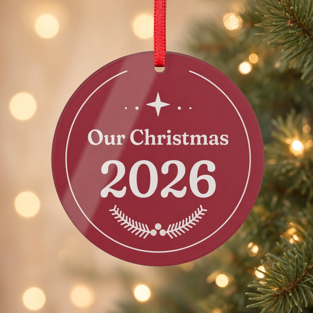 Close-up of the burgundy Our Christmas 2026 acrylic ornament with star and pine sprig design